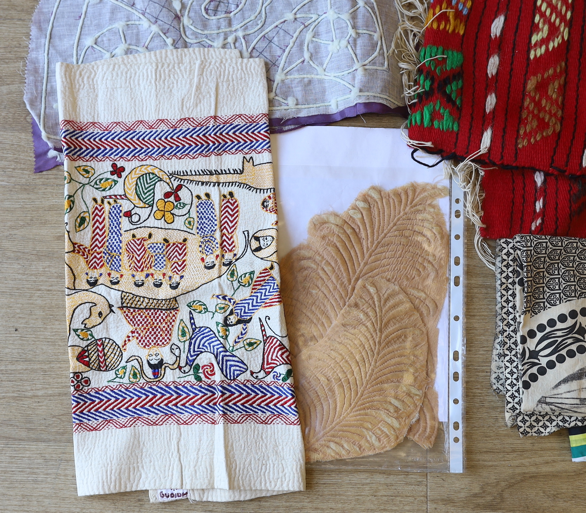 A cotton printed African religious commemorative panel, dated 1897-1957, together with various samples of types of quilting, hand painted silk and woven textiles